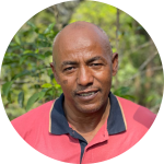 Portrait of the coffee producer outdoors with an overlaid quote about preserving nature