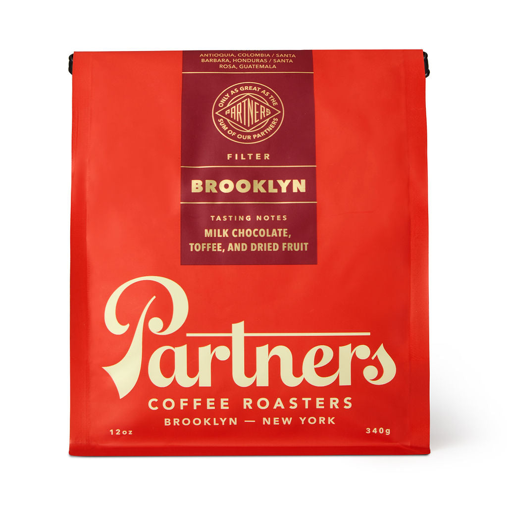 Front view of Brooklyn coffee bag showcasing red packaging and Partners Coffee logo on white background