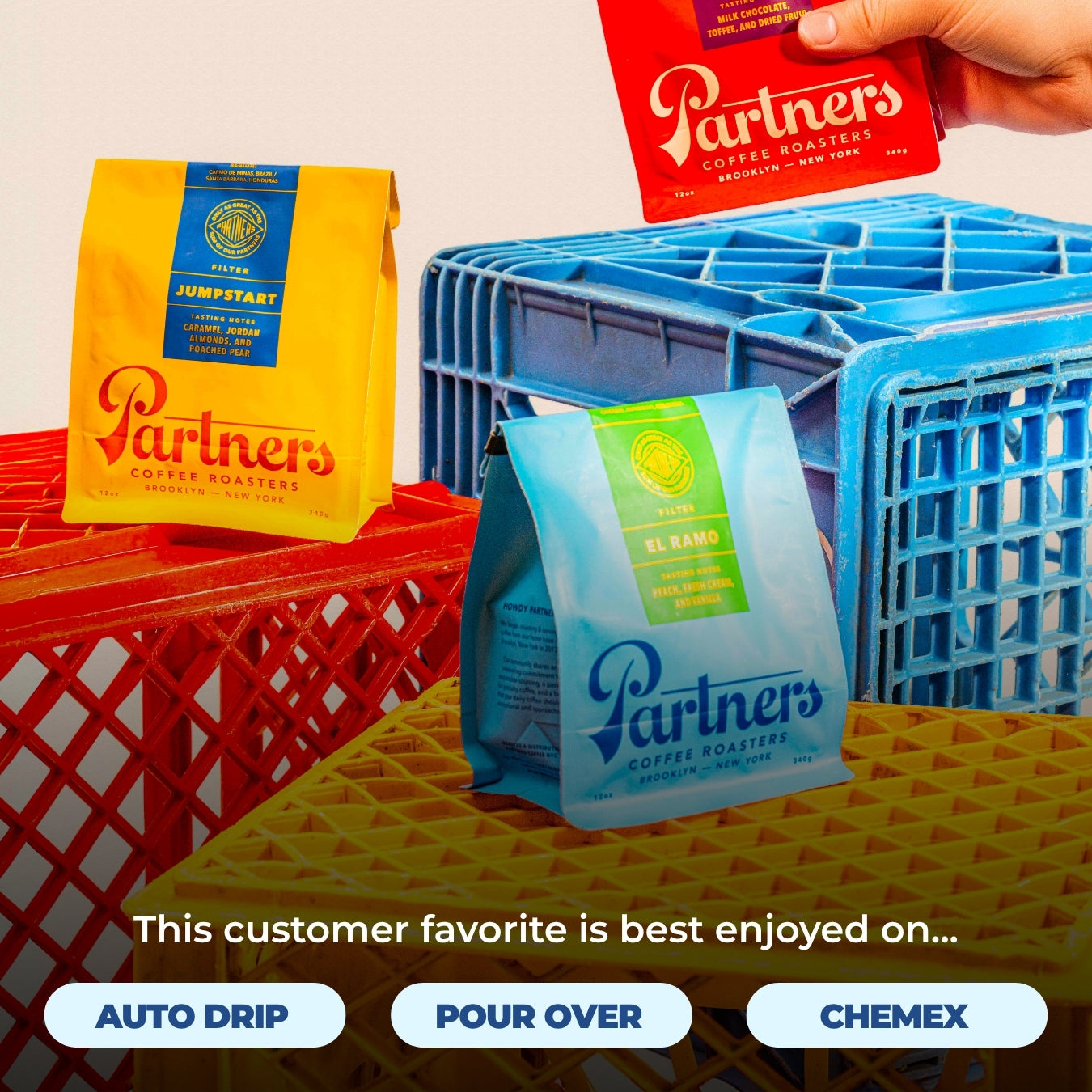 Blue El Ramo coffee bag with two other Partners Coffee bags on colorful milk crates; overlay text: This customer favorite is best enjoyed on...