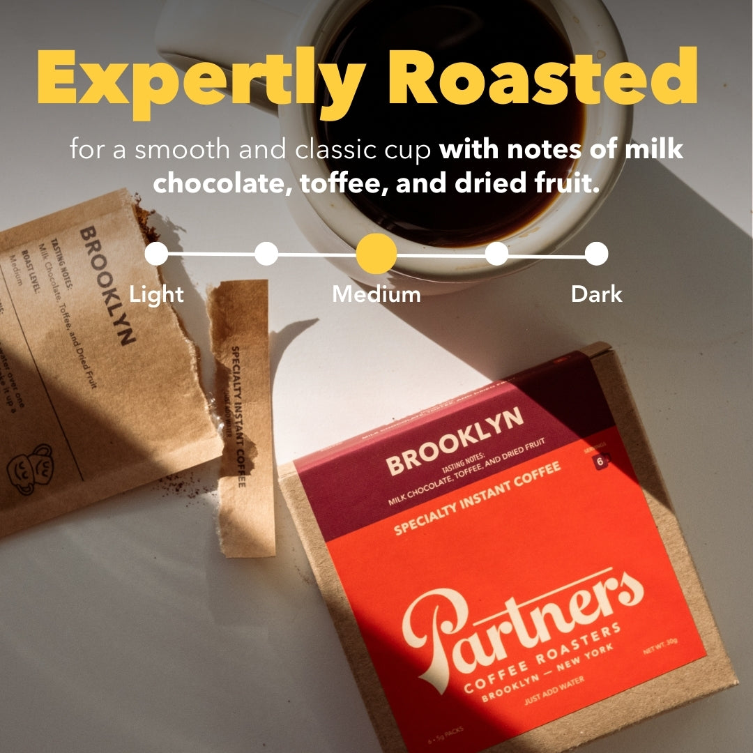 Angled view of Brooklyn instant coffee box and torn sachet, overlay Expertly Roasted, medium roast, notes of milk chocolate