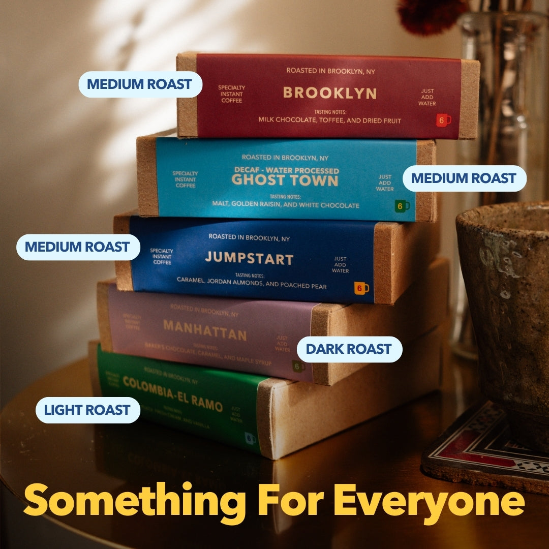 Promotional photo showing stacked Partners Coffee instant coffee boxes labeled light, medium, and dark roast with headline ‘Something For Everyone’