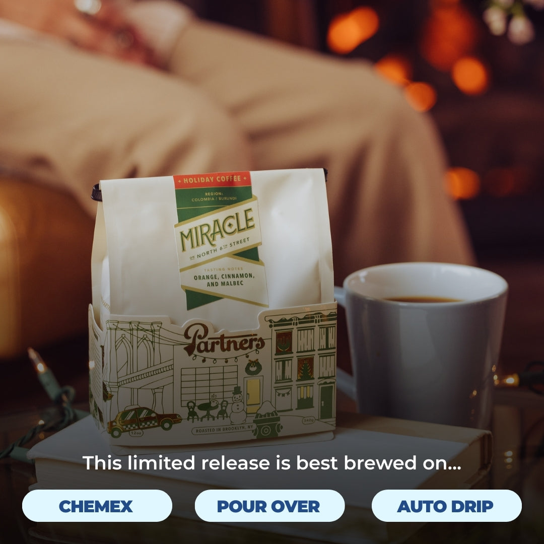 Bag of Miracle holiday coffee beside a mug in a cozy holiday setting with overlay ‘This limited release is best brewed on’