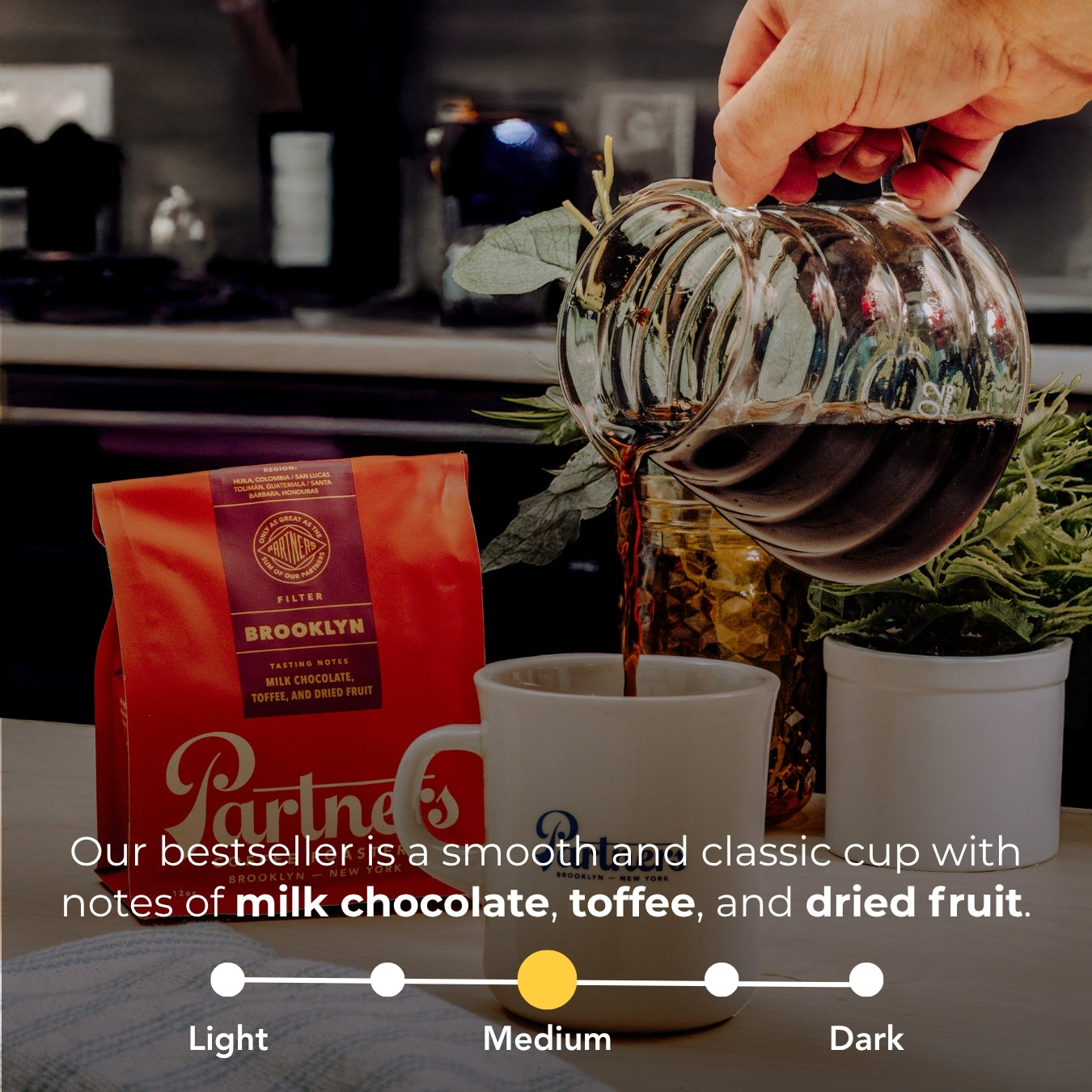Hand pouring coffee into mug beside red Brooklyn blend bag, overlay tasting notes: milk chocolate, toffee, dried fruit