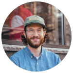Green coffee buyer smiling in a blurred outdoor setting