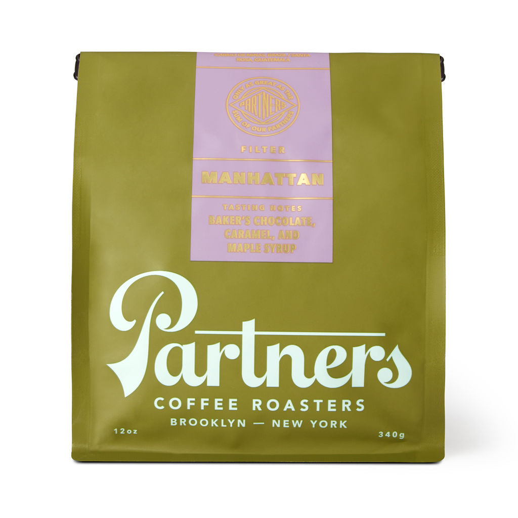 Front view of Manhattan coffee bag showcasing olive green packaging and Partners logo on white background